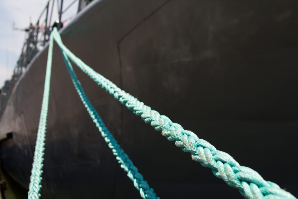 mooring ropes holding the ship at the pier